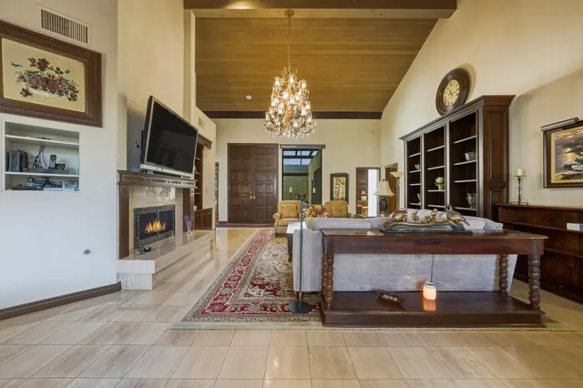 a living room with fireplace furniture and a flat screen tv