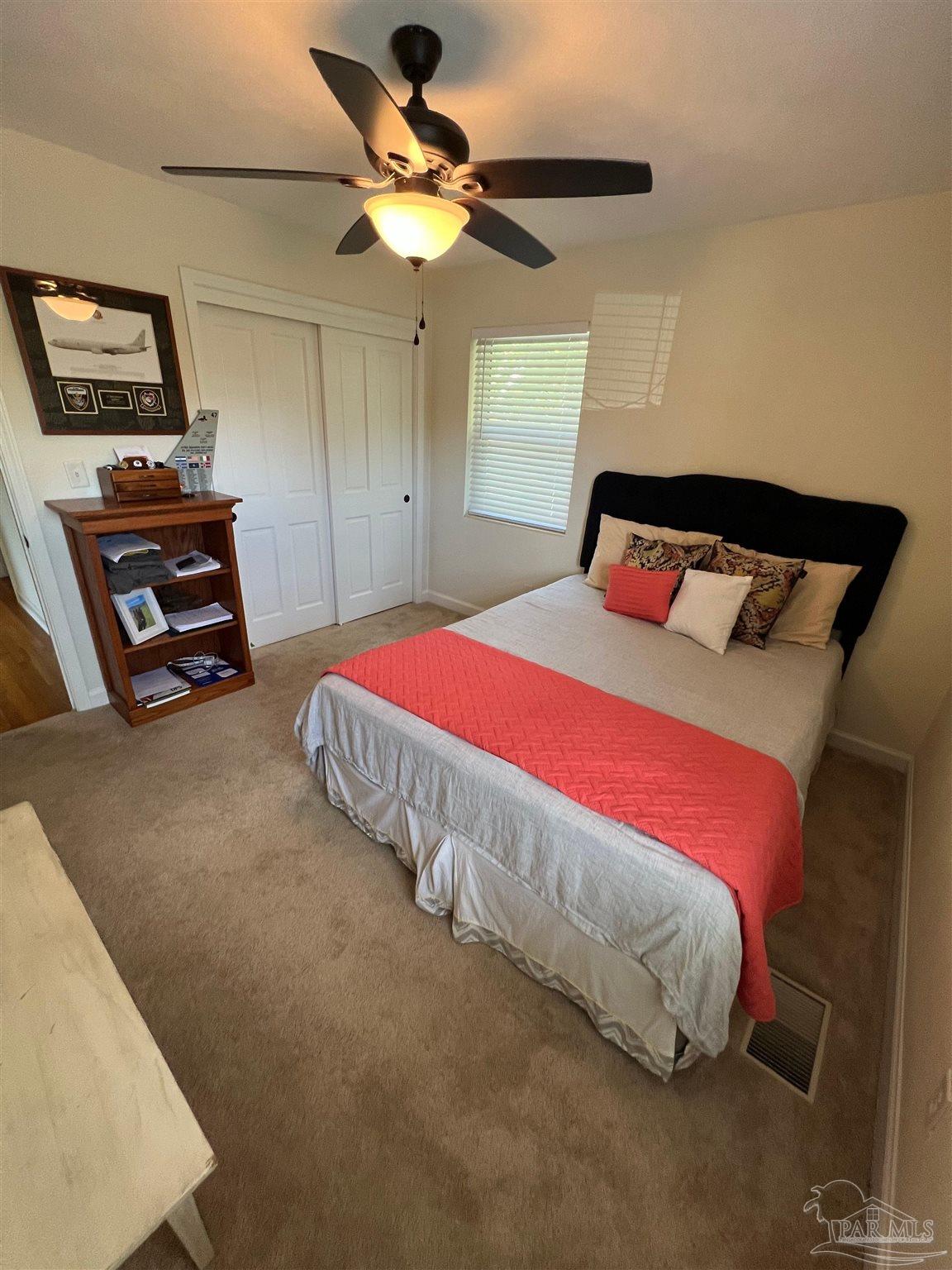 320 Gamarra Road Pensacola, FL 32503 - Photo 14 of 29 a bedroom with a bed and a chandelier