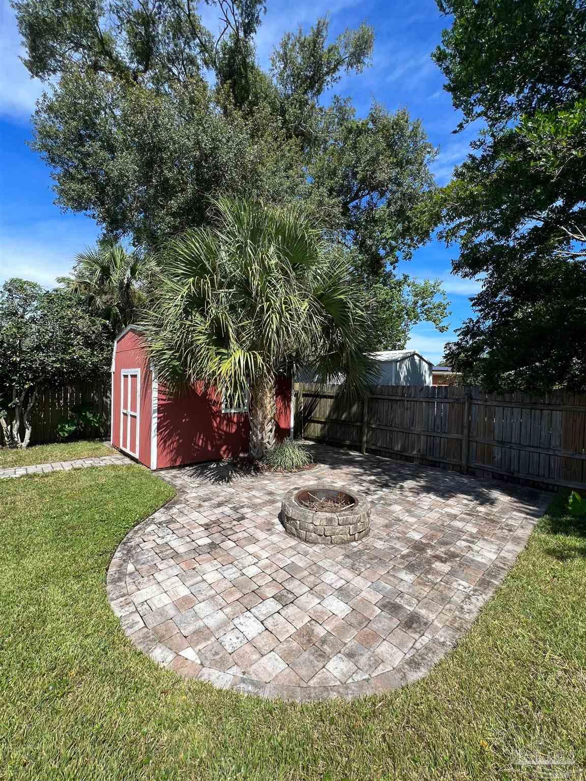 320 Gamarra Road Pensacola, FL 32503 - Photo 28 of 29 a backyard of a house with lots of green space
