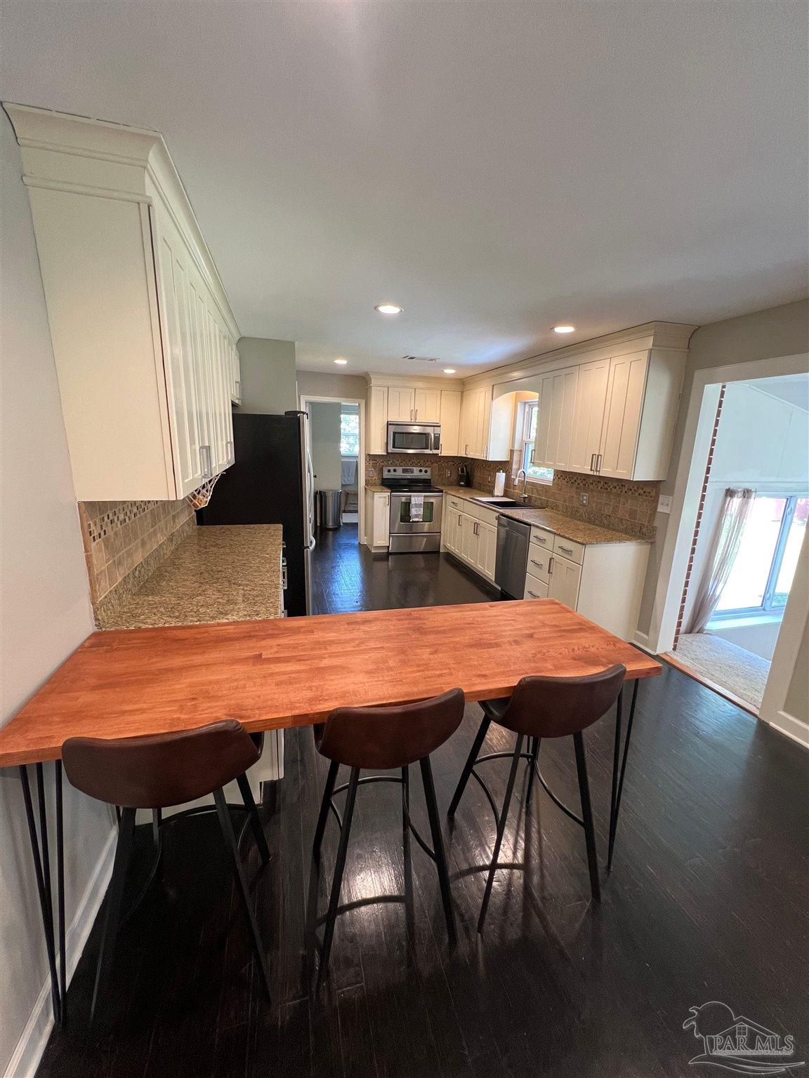 320 Gamarra Road Pensacola, FL 32503 - Photo 7 of 29 a dining room dining table chairs and a kitchen view