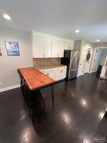 a living room with hard wood floors and a table