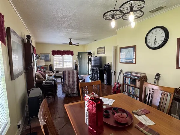 a view of a dining room with furniture kitchen and wooden floor