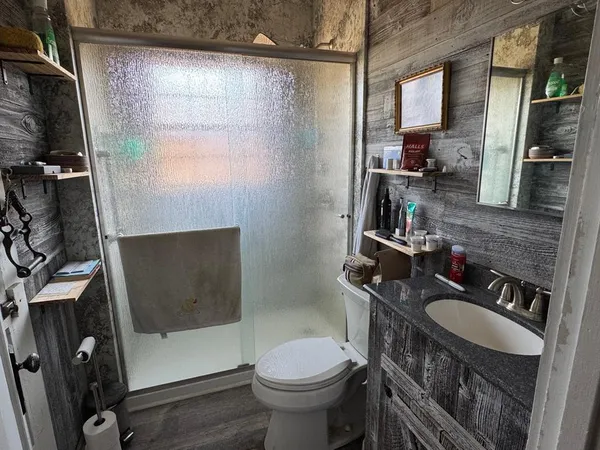 a bathroom with a sink toilet and shower