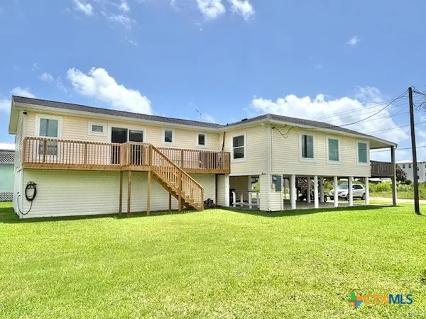 a view of a house with a big yard and sitting area