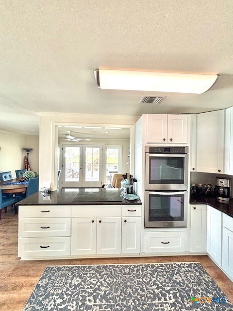 604 Maple Street Port O'Connor, TX 77982 - Photo 13 of 46 a kitchen with a sink cabinets and stainless steel appliances