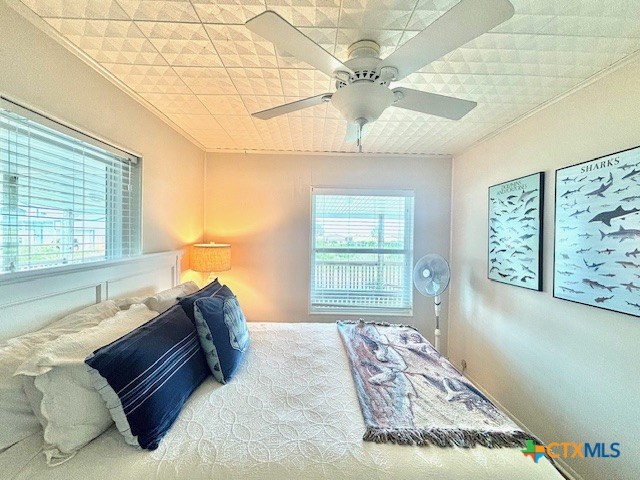604 Maple Street Port O'Connor, TX 77982 - Photo 19 of 46 a bedroom with a large bed and a window