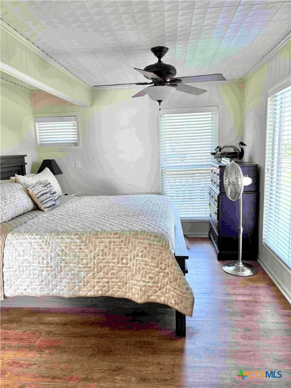 604 Maple Street Port O'Connor, TX 77982 - Photo 29 of 46 a bedroom with a bed and wooden floor