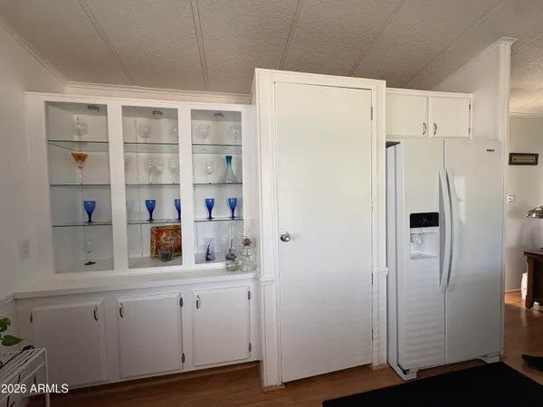 a kitchen with stainless steel appliances granite countertop a sink refrigerator and cabinets