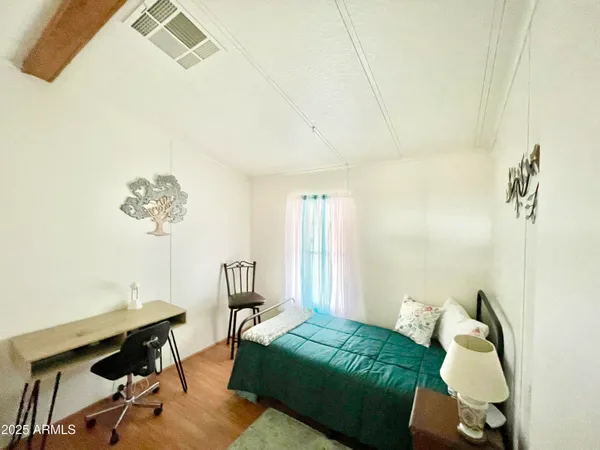 a bedroom with a bed and a table in it