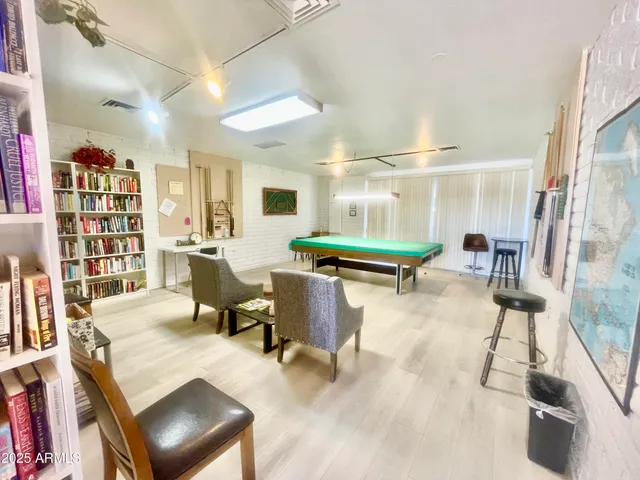 a large white kitchen with a table and chairs in it