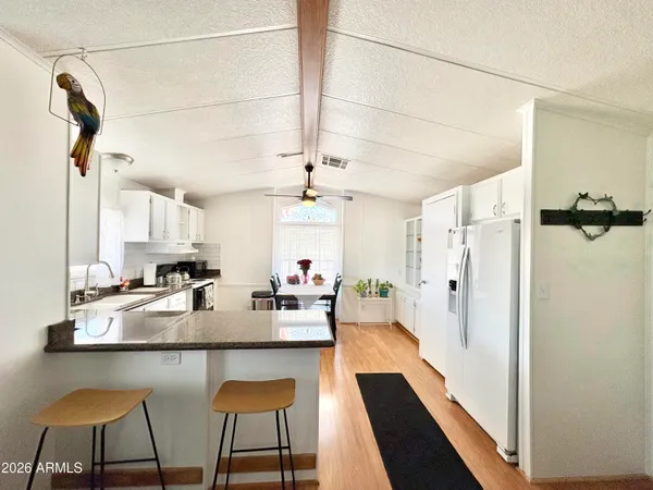 a view of a patio with table and chairs under an umbrella
