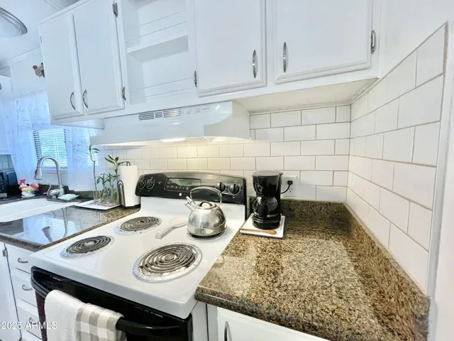 a kitchen with a table and cabinets