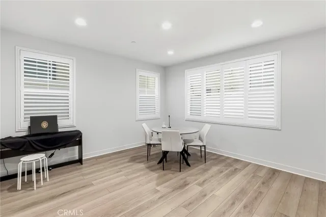 a dining room with wooden floor and a window