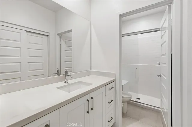 a bathroom with a shower sink and mirror