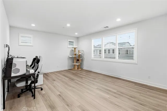 a view of a workspace with furniture and a window