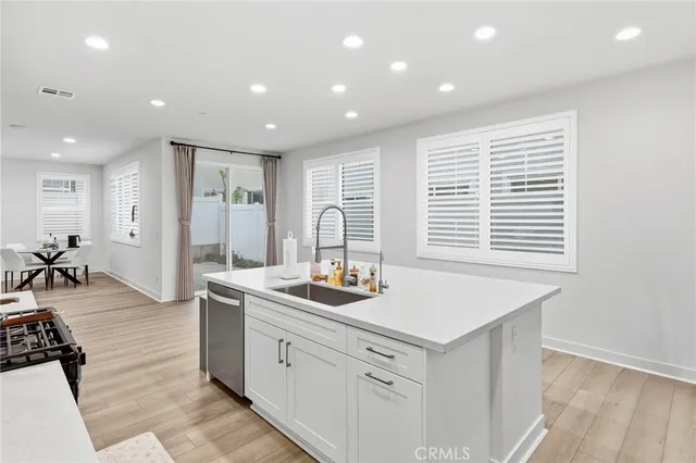 a kitchen with a sink stove and cabinets