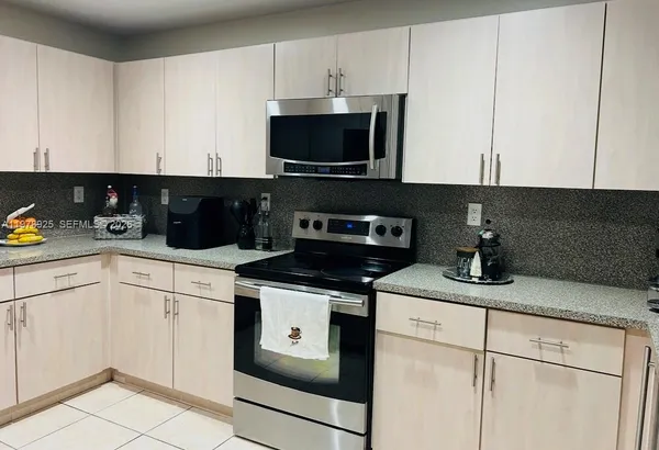 a kitchen with a sink and white cabinets