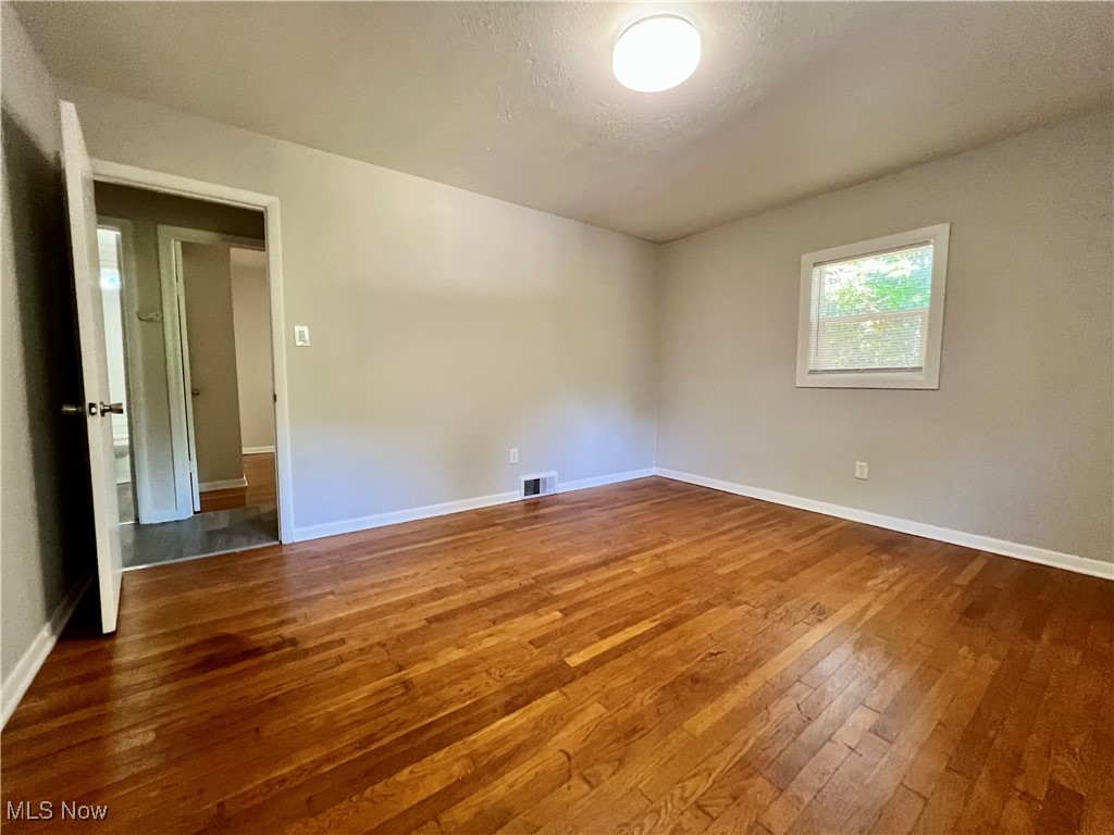 2972 North Turkeyfoot Road Akron, OH 44319 - Photo 25 of 32 Spare room with dark wood finished floors and a textured ceiling