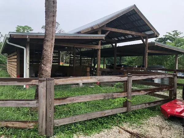 a view of a house that has a porch and a floor to ceiling window