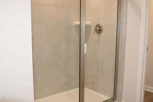 a bathroom with a glass shower door