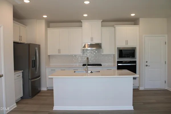 a large kitchen with stainless steel appliances