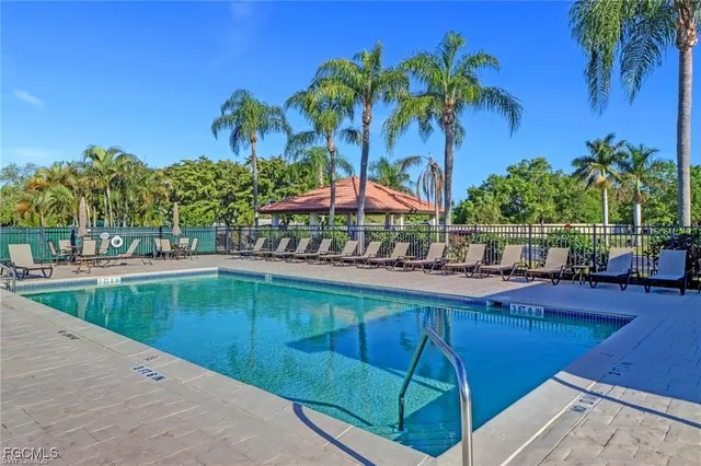 a swimming pool with outdoor seating and yard