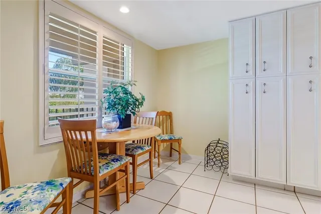 a view of a dining room with furniture and a potted plant