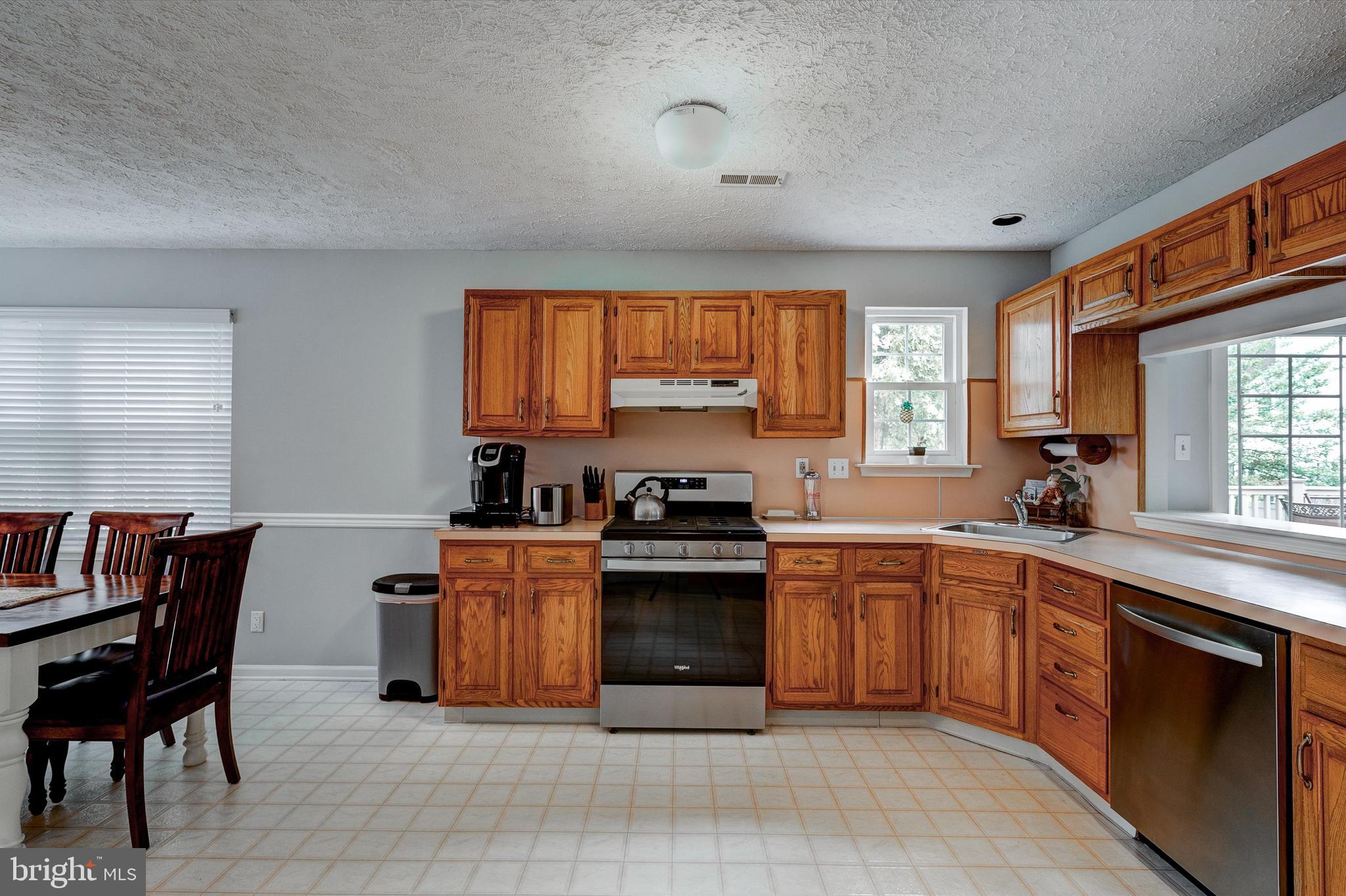 105 Annapolis Drive Sicklerville, NJ 08081 - Photo 12 of 56 a kitchen with stainless steel appliances granite countertop a stove top oven a sink dishwasher and a refrigerator