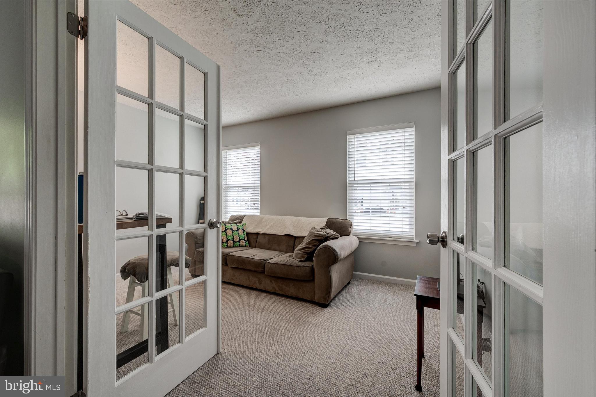 105 Annapolis Drive Sicklerville, NJ 08081 - Photo 19 of 56 a living room with furniture and a floor to ceiling window