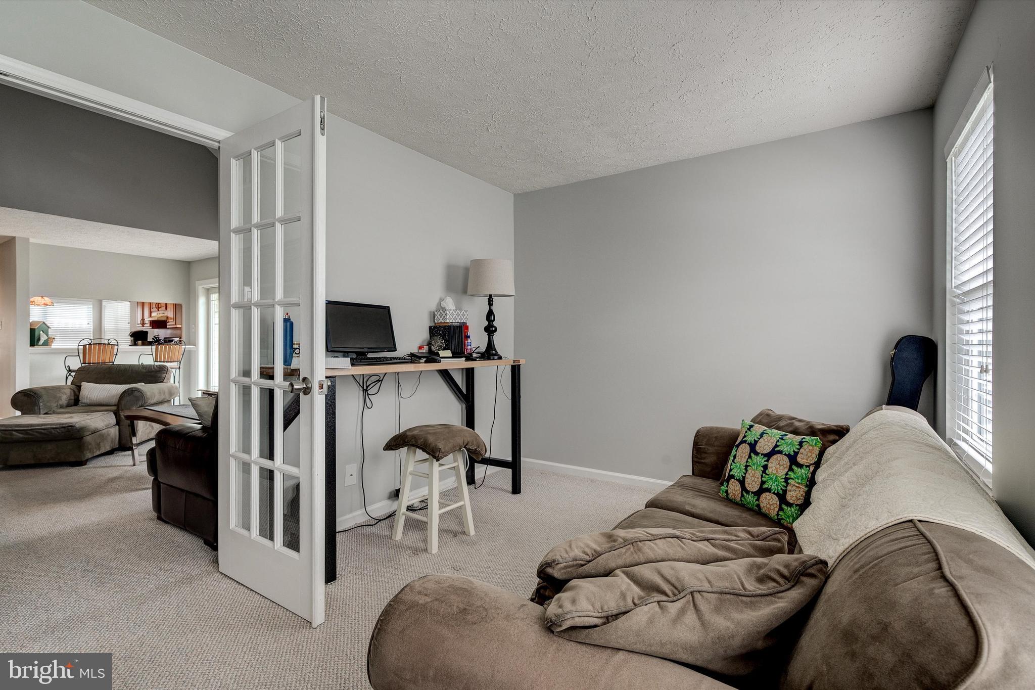 105 Annapolis Drive Sicklerville, NJ 08081 - Photo 20 of 56 a living room with furniture and a flat screen tv