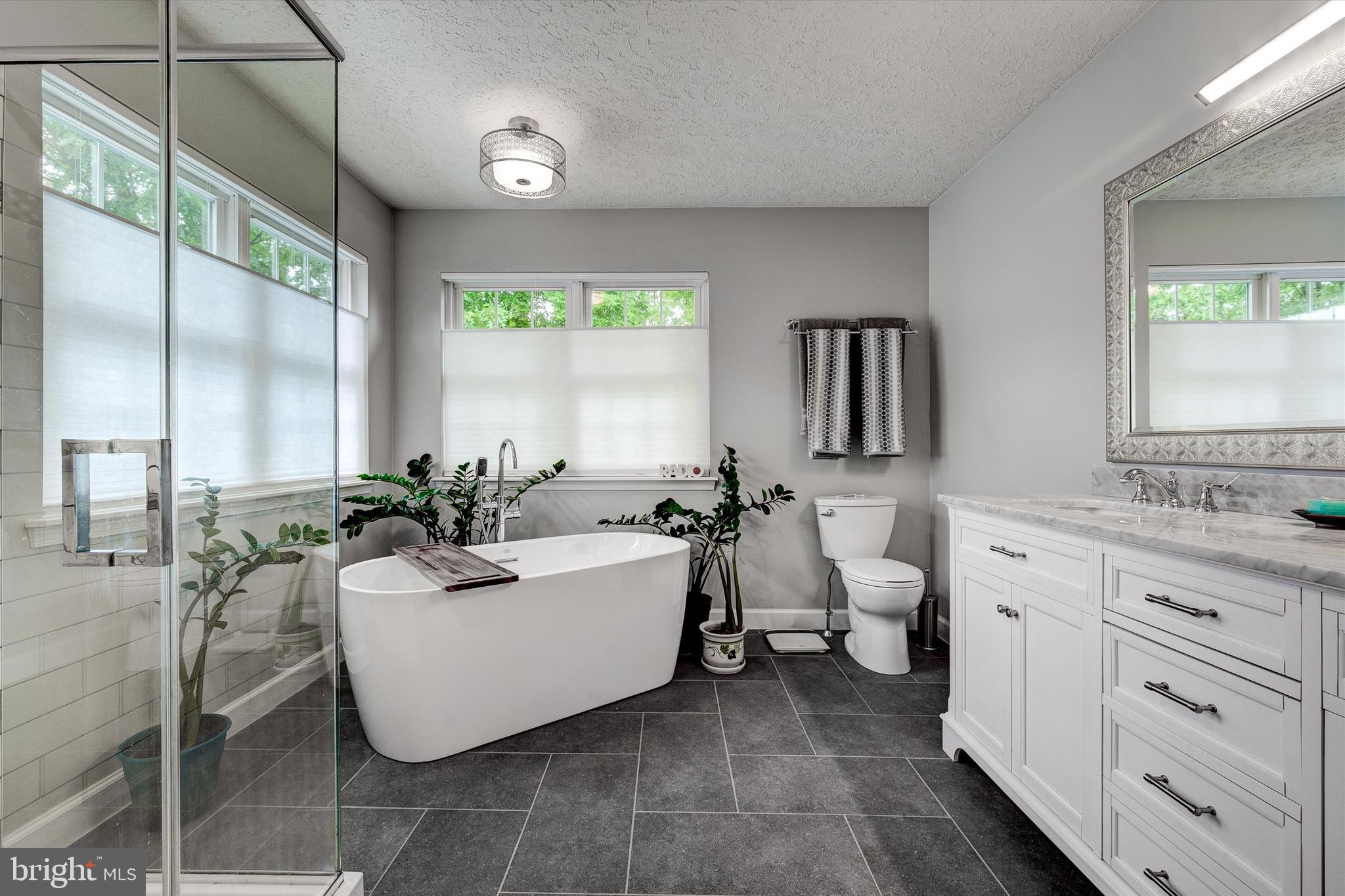 105 Annapolis Drive Sicklerville, NJ 08081 - Photo 27 of 56 a spacious bathroom with a double vanity sink a mirror and a bathtub