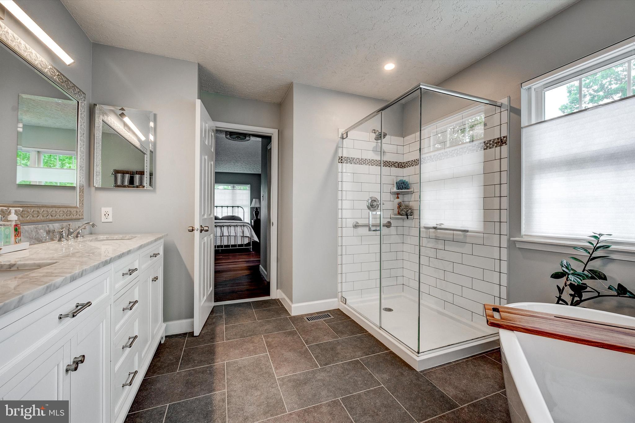 105 Annapolis Drive Sicklerville, NJ 08081 - Photo 28 of 56 a bathroom with a shower sink and mirror