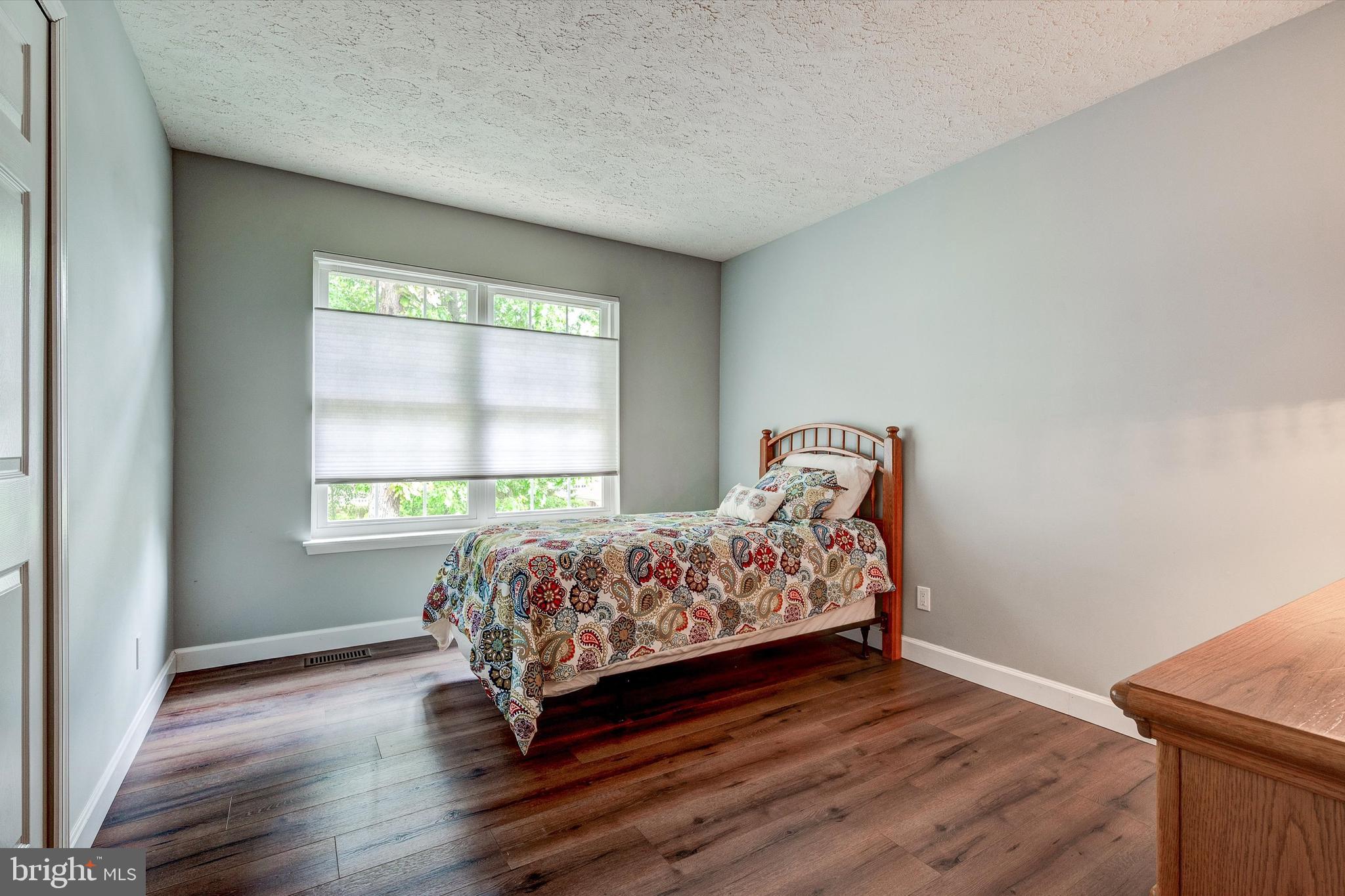 105 Annapolis Drive Sicklerville, NJ 08081 - Photo 38 of 56 a bedroom with a bed and wooden floor