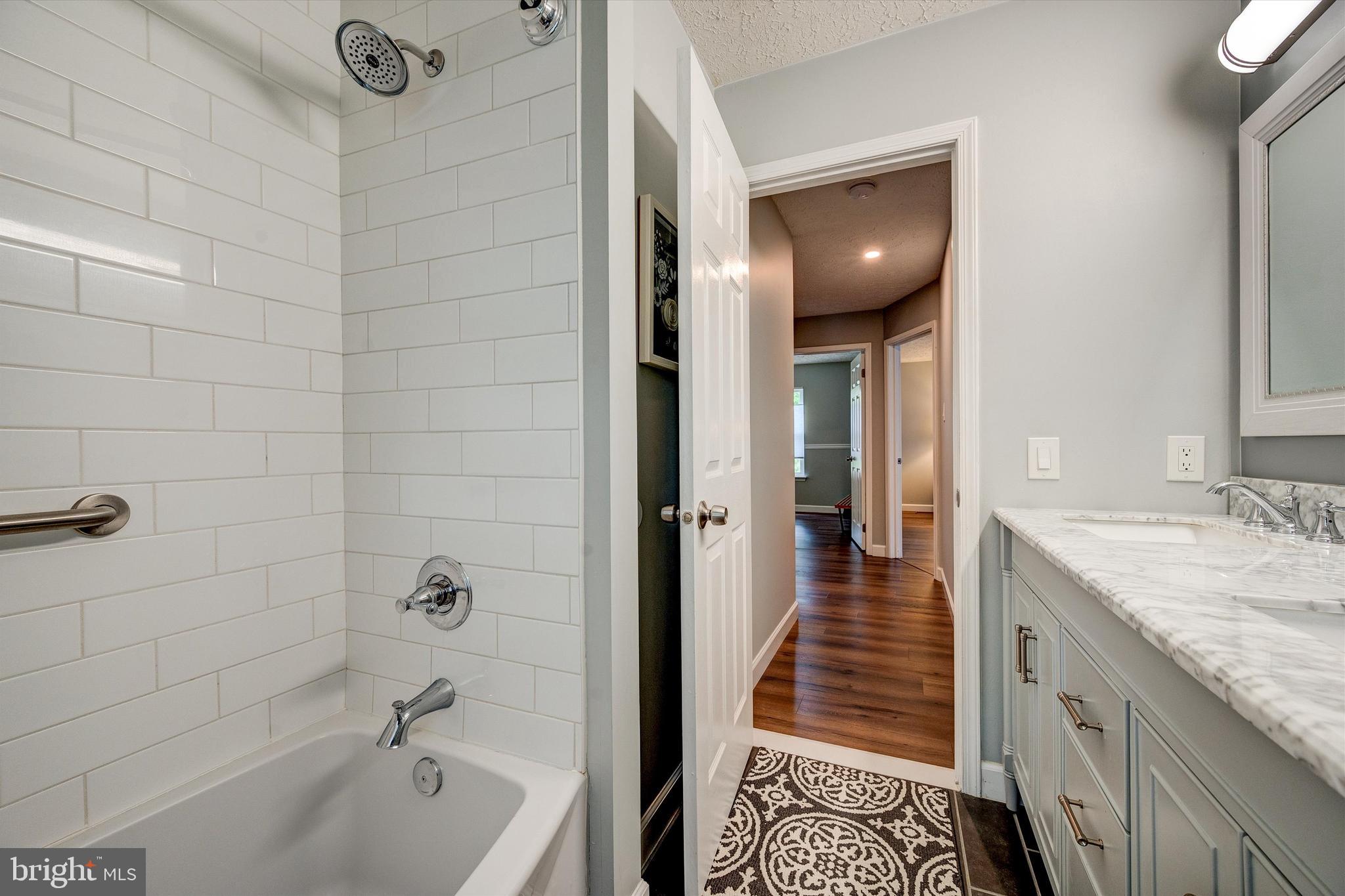 105 Annapolis Drive Sicklerville, NJ 08081 - Photo 39 of 56 a bathroom with a granite countertop sink a toilet and bathtub
