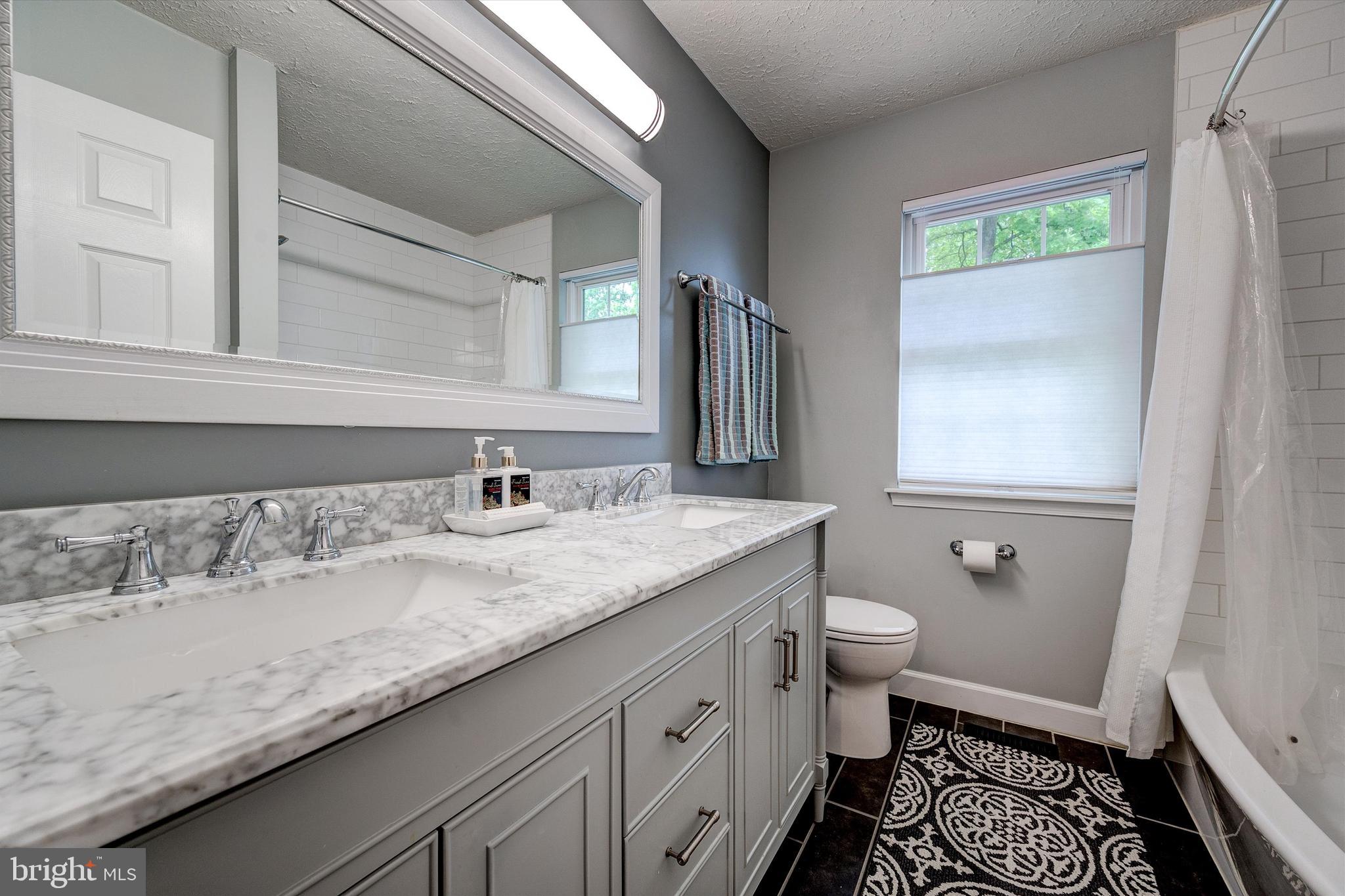 105 Annapolis Drive Sicklerville, NJ 08081 - Photo 40 of 56 a bathroom with a granite countertop sink and a mirror