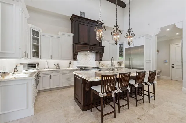 a kitchen with cabinets appliances and a center island