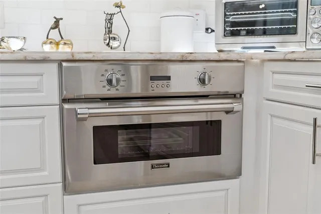 a stove top oven sitting inside of a kitchen