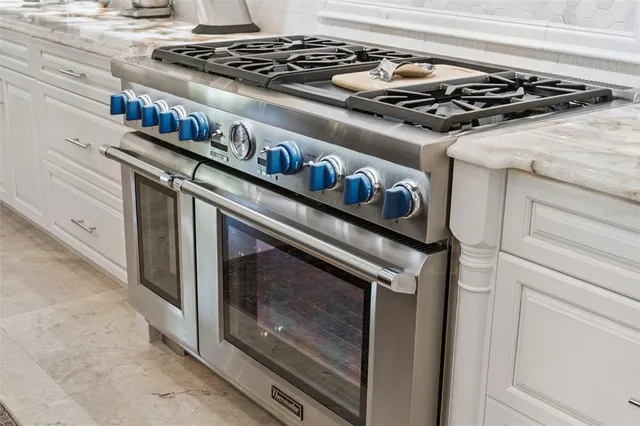 a stove top oven sitting inside of a kitchen