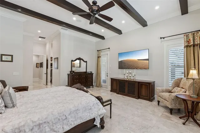 a large bedroom with a bed and a flat screen tv