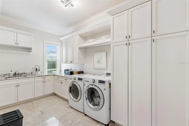 a utility room with sink dryer and washer