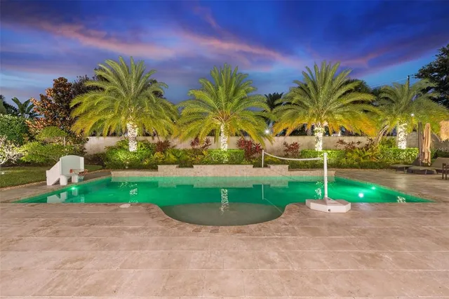 a view of a swimming pool with a table and chairs