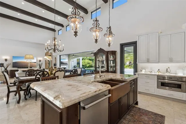 a kitchen with a stove a sink a dining table and chairs