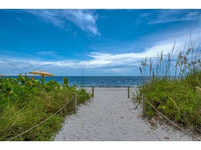 a view of a yard with wooden fence
