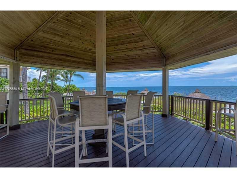 1111 Crandon Boulevard, Unit B804 Key Biscayne, FL 33149 - Photo 14 of 19 a dining space with furniture and wooden floor