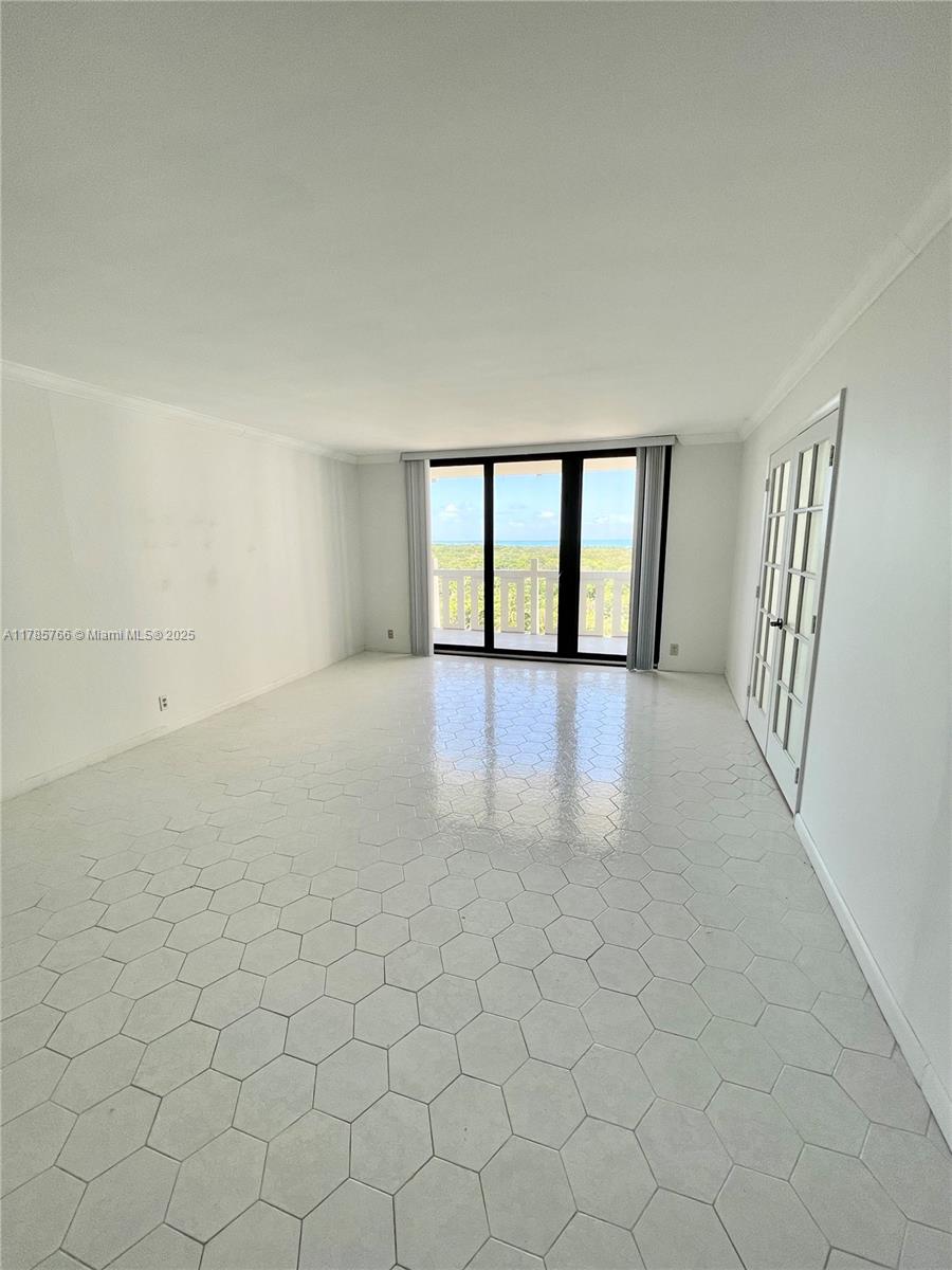 1111 Crandon Boulevard, Unit B804 Key Biscayne, FL 33149 - Photo 2 of 19 wooden floor in an empty room with a window