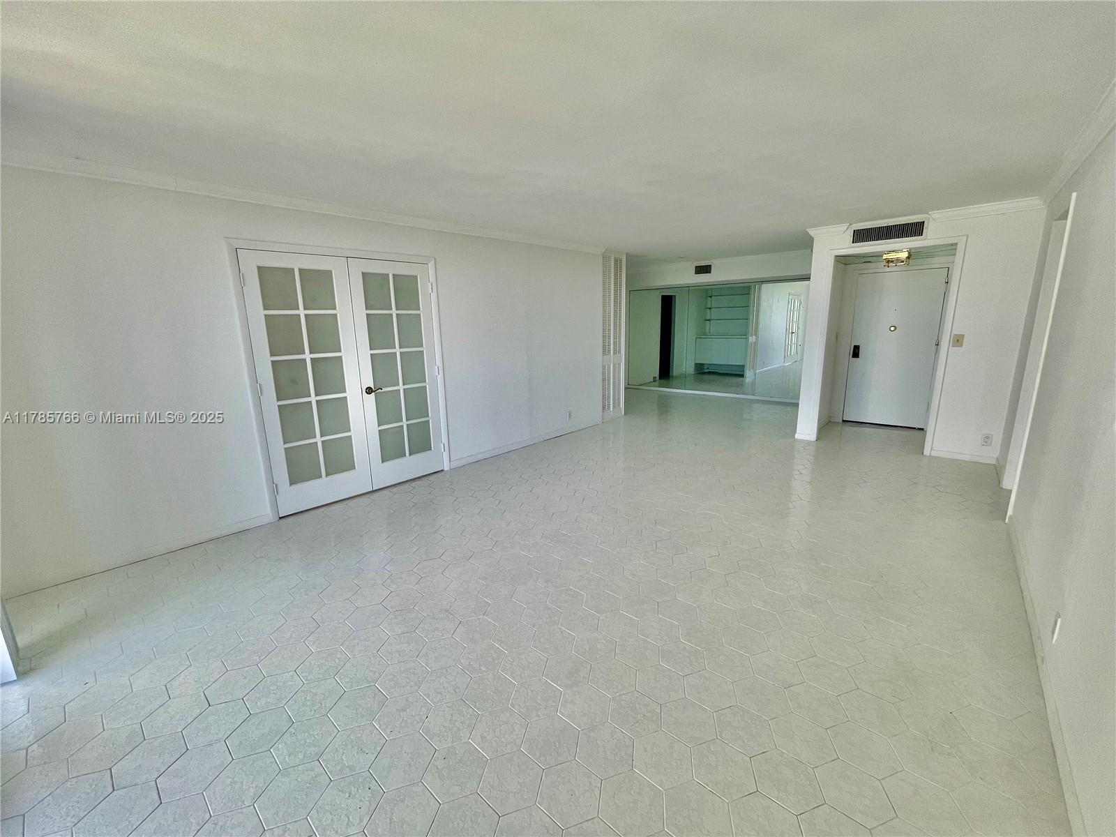 1111 Crandon Boulevard, Unit B804 Key Biscayne, FL 33149 - Photo 3 of 19 an empty room with a window and a kitchen