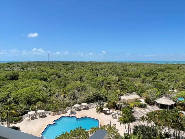 an aerial view of a houses with a yard