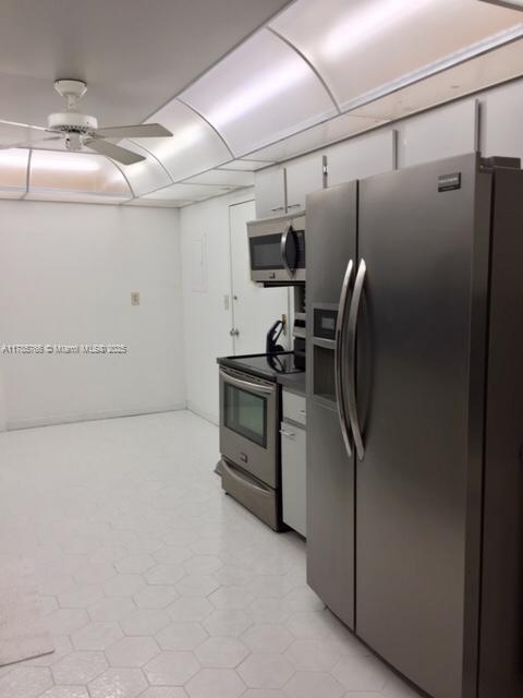 1111 Crandon Boulevard, Unit B804 Key Biscayne, FL 33149 - Photo 8 of 19 a view of a refrigerator in kitchen and a window
