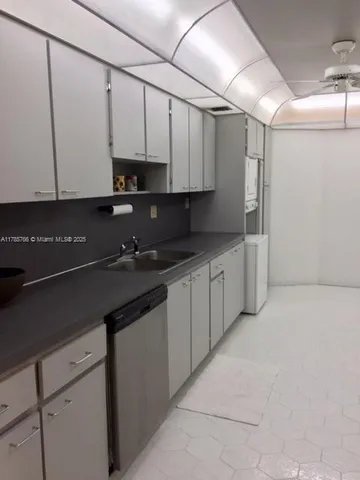 a kitchen with stainless steel appliances granite countertop a sink a stove and a refrigerator