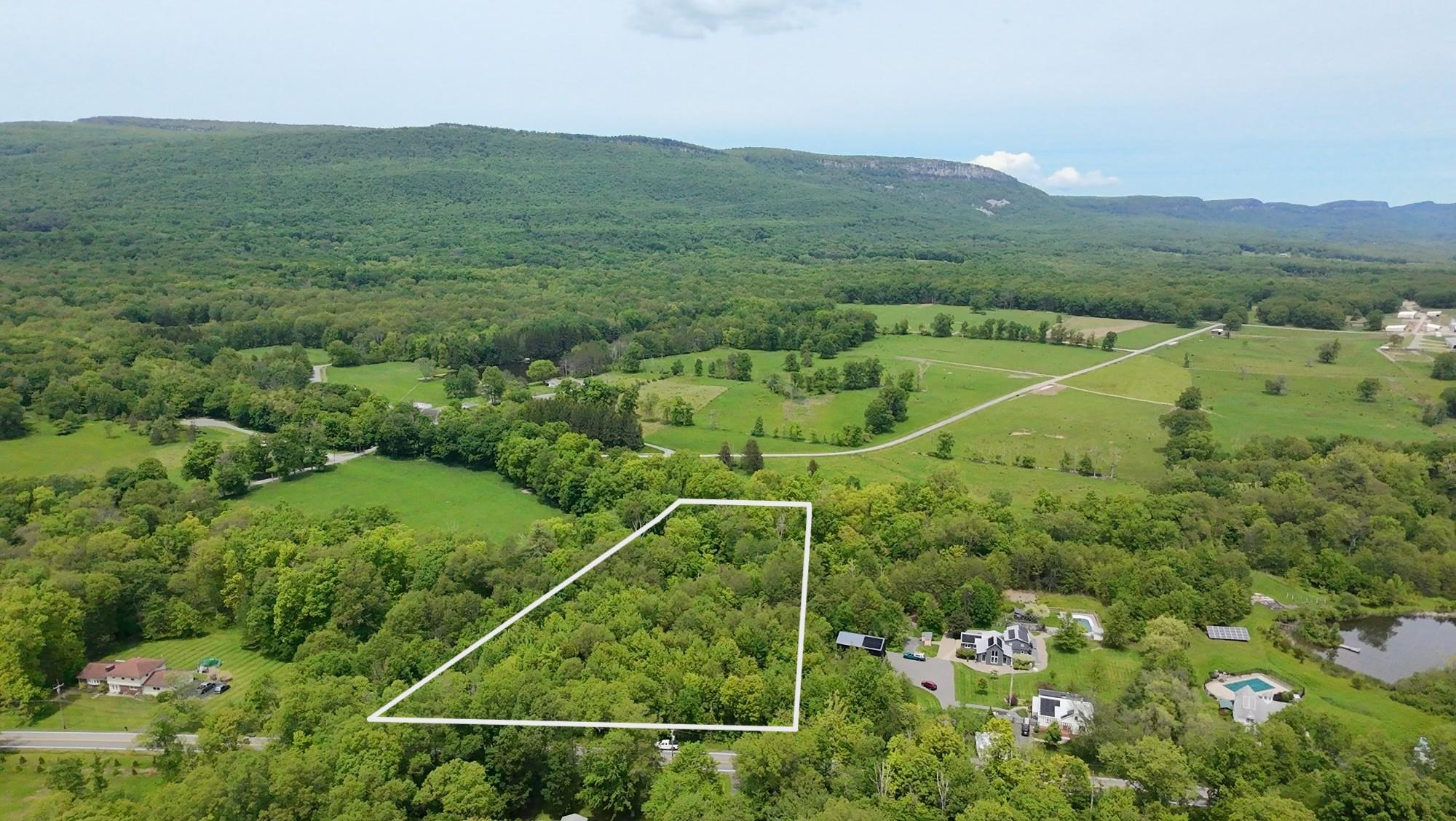 a view of a field with an ocean